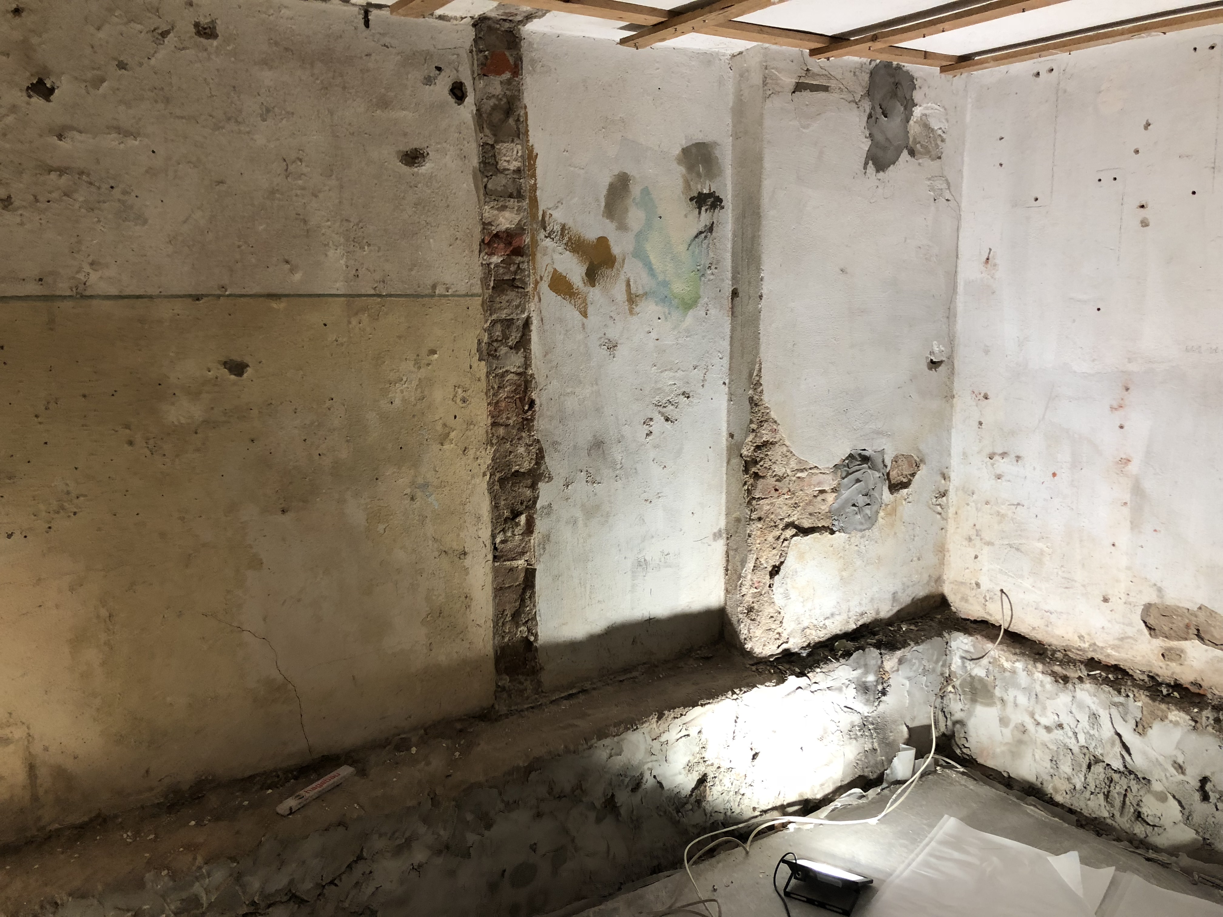 Feuchte Kellerwand mit beschädigtem Putz und typischen Salz- und Feuchteschäden durch langanhaltende Durchfeuchtung